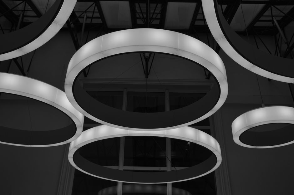 A striking arrangement of modern circular light fixtures captured in a low angle shot.