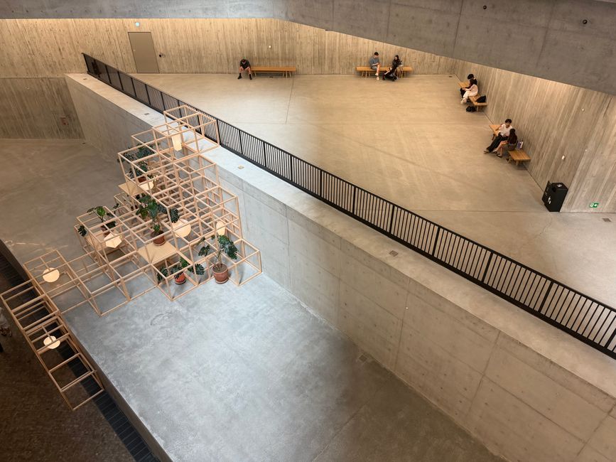 Spacious indoor area with a minimalist design and concrete elements.
