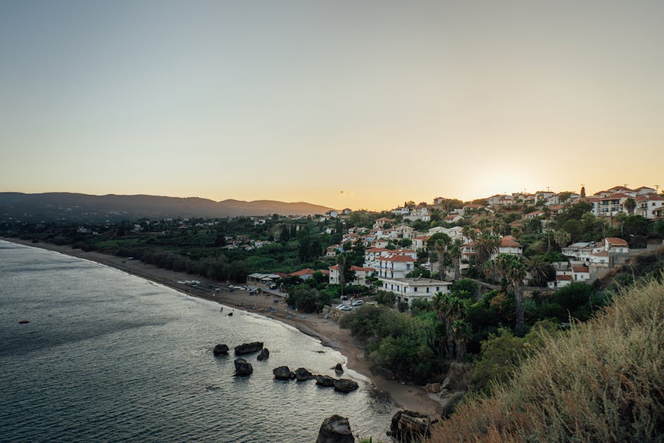 Dramatic sunset over Koroni, Greece with coastal views and traditional architecture.